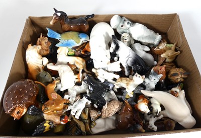 Lot 185 - A collection of pottery figures of animals to...