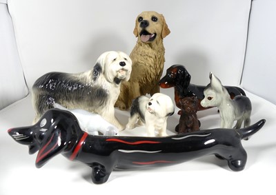 Lot 186 - A collection of pottery figures of dogs...