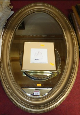 Lot 1071 - A gilt framed composition bevelled oval wall...