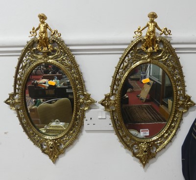 Lot 588 - A pair of Victorian style oval hall mirrors...