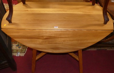 Lot 1307 - An Ercol pine compact kitchen table, raised on...