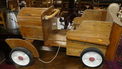 Lot 1314 - A child's vintage stained pine and ply ride-on...