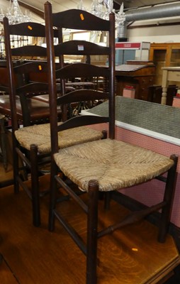 Lot 1329 - A pair of early 20th century oak ladderback...