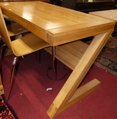 Lot 1338 - A contemporary blond oak office desk, having...