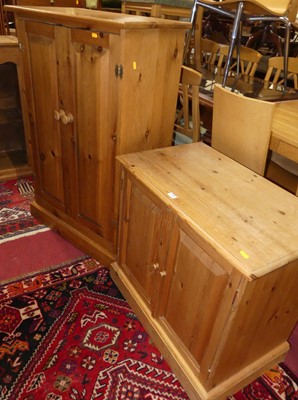 Lot 1340 - A modern pine double-door side cupboard,...