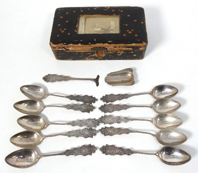 Lot 283 - A set of eight white metal coffee spoons, each...