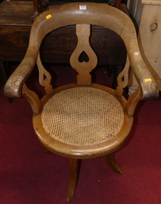 Lot 1393 - A late Victorian oak tub swivel desk chair,...