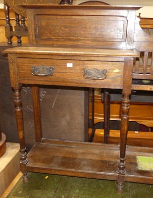 Lot 1408 - An early 20th century oak hall stand, with...