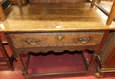 Lot 1424 - An 18th century oak plank top single drawer...