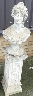 Lot 1468 - A reconstituted stone pedestal garden bust of...