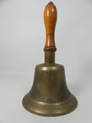 Lot 485 - A cast brass bell having a turned wooden...