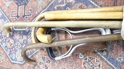 Lot 513 - A collection of walking sticks together with a...