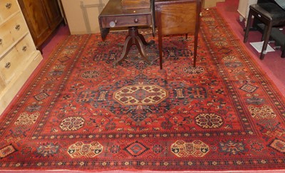 Lot 1148 - A Persian style machine woven red ground...