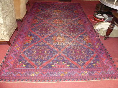 Lot 1150 - A Persian woollen bright coloured ground...