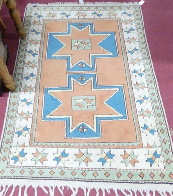 Lot 1151 - A Turkish woollen orange and cream ground rug,...