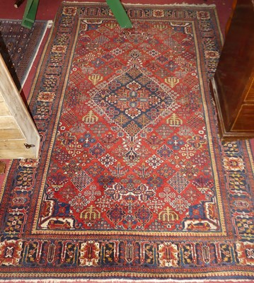 Lot 1154 - A Persian woollen red and blue ground Qashqai...