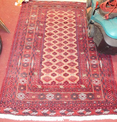 Lot 1158 - A Persian woollen red ground Bokhara rug...