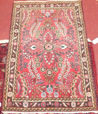 Lot 1159 - An Afghan woollen red ground medallion hall...