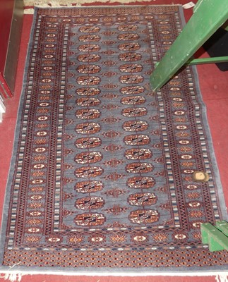 Lot 1166 - A Persian woollen blue ground Bokhara hall rug,...