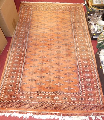 Lot 1170 - A Persian woollen red ground Bokhara rug, 210...