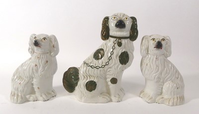 Lot 114 - A pair of Staffordshire seated spaniels, each...