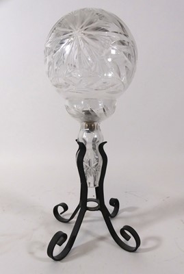 Lot 127 - A cut glass spherical lamp on wrought iron...