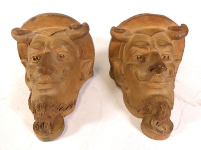 Lot 161 - A pair of continental terracotta mask wall...