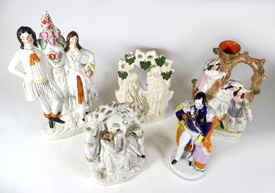 Lot 233 - A group of five Staffordshire pottery figures...