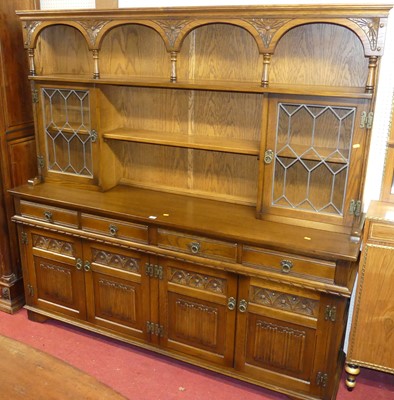 Lot 1140 - An Old Charm oak dresser, having open shelves...