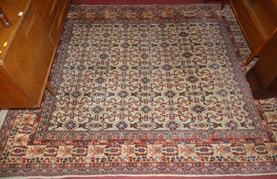 Lot 1158 - A Persian woollen cream ground Bokhara rug,...