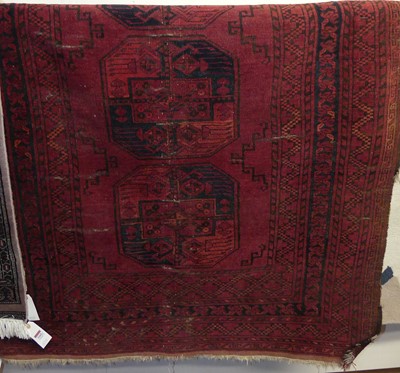 Lot 1164 - A Persian woollen red ground Bokhara rug, 210...