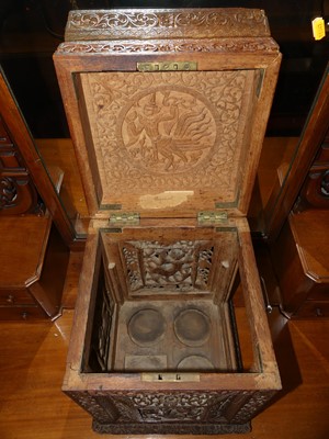 Lot 1210 - A 19th century Burmese carved teak tantalus...