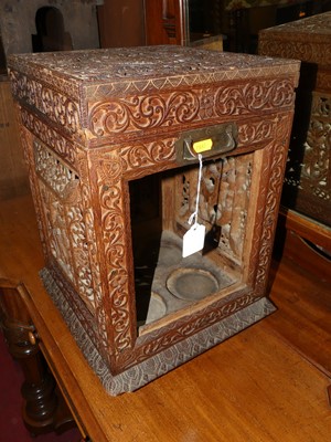 Lot 1210 - A 19th century Burmese carved teak tantalus...
