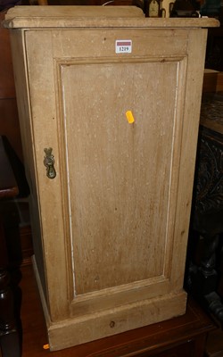 Lot 1219 - A pine ledge back single door bedside cupboard,...