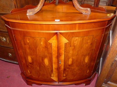 Lot 1267 - A reproduction yew low double door bow front...