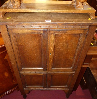 Lot 1252 - A 1930s oak four-door side cupboard, width 63.5cm