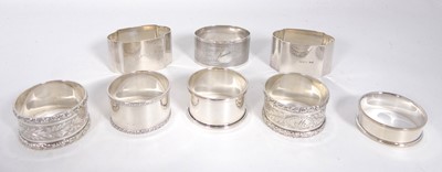 Lot 388 - A collection of eight silver napkin rings,...