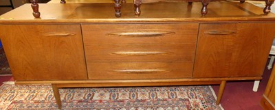 Lot 1279 - A 1960s teak long sideboard, having three...