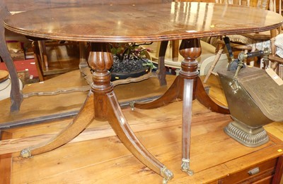 Lot 1284 - A mahogany twin pillar pedestal dining table,...