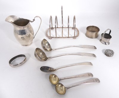 Lot 394 - A collection of silver to include a cream jug,...