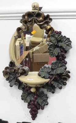 Lot 689 - A carved wooden wall hanging mirror decorated...