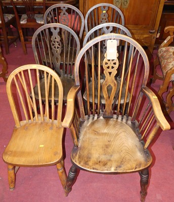 Lot 1326 - A set of four ebonised elm and beech wheelback...