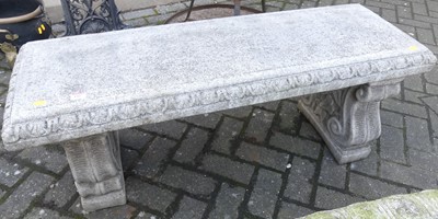 Lot 1427 - A reconstituted stone garden twin bench seat,...