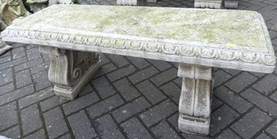 Lot 1429 - A reconstituted stone two-seater garden bench...