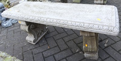 Lot 1430 - A reconstituted stone two-seater garden bench...