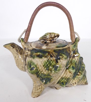 Lot 338 - A majolica teapot in the form of a shell,...