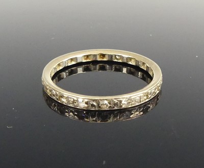 Lot 432 - An 18ct white gold diamond eternity ring,...