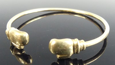 Lot 489 - A child's 9ct gold bangle, the ends each set...