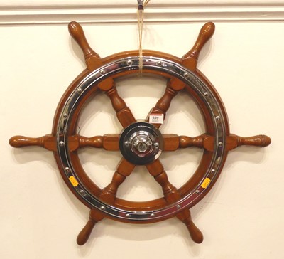 Lot 559 - A reproduction chrome mounted ship's wheel,...