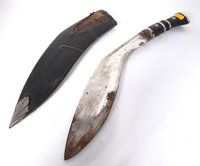 Lot 573 - A Nepalese kukri having a chromed metal blade...